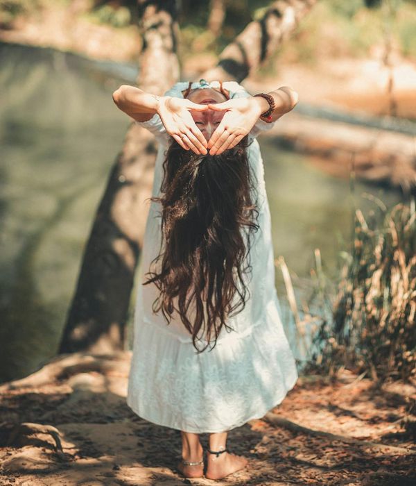 Woman performing a gentle yoga flow in a calm environment.